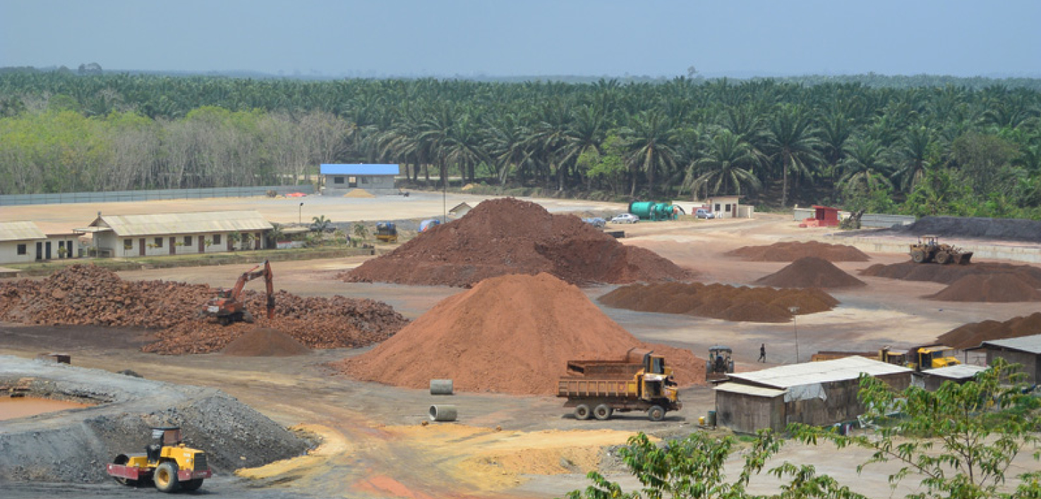 Open-pit mineral processing site with earthmoving vehicles